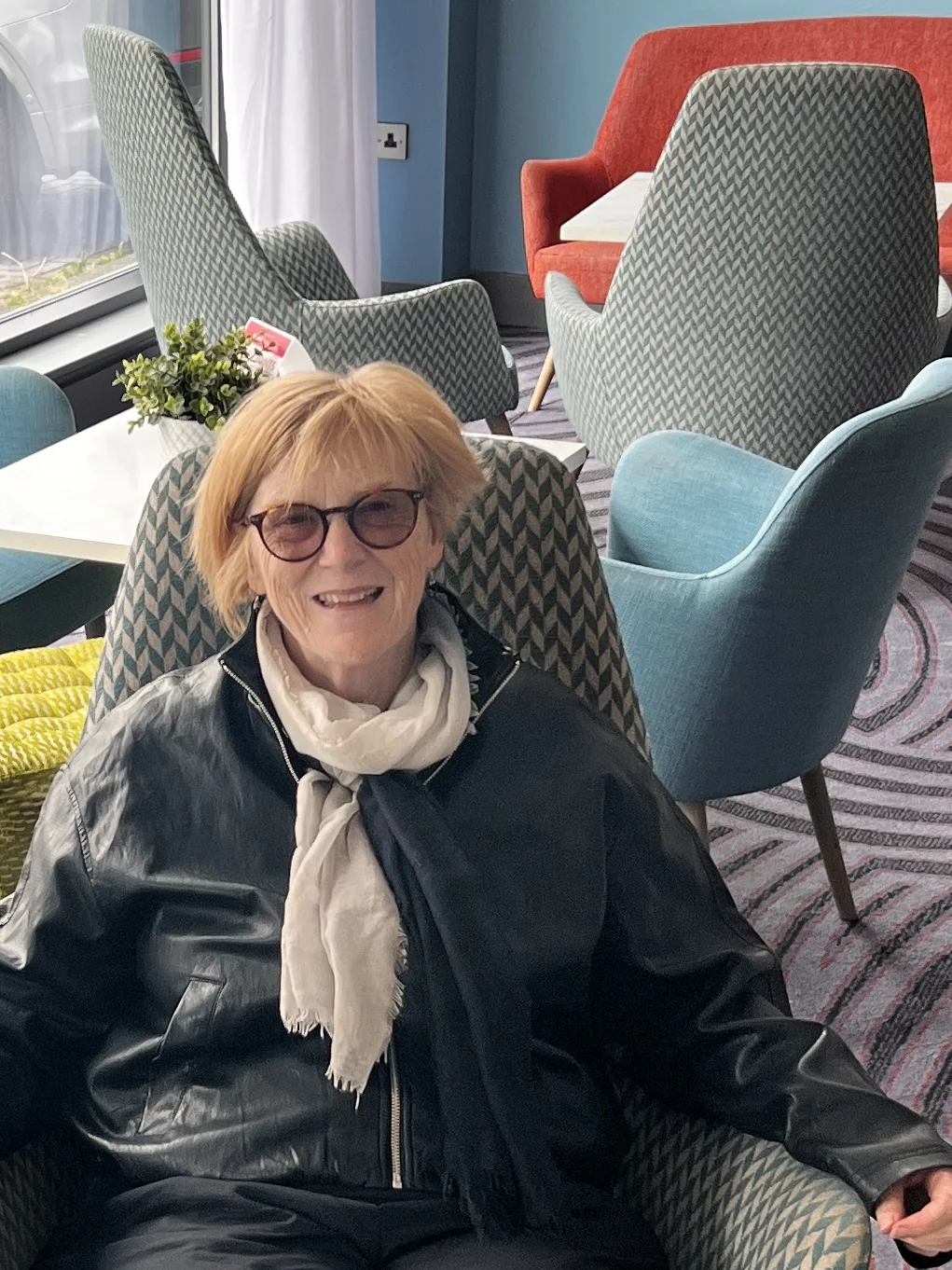 Carol seated and smiling
